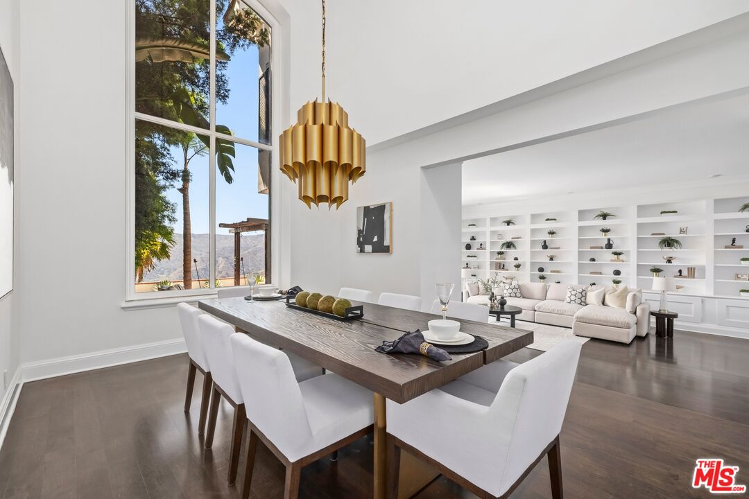 2241 Canyonback Road Los Angeles, CA 90049 - Photo 4 of 26 a view of a dining room with furniture wooden floor and a chandelier