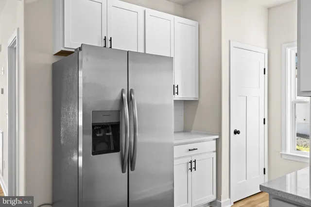 a kitchen with stainless steel appliances refrigerator and cabinets