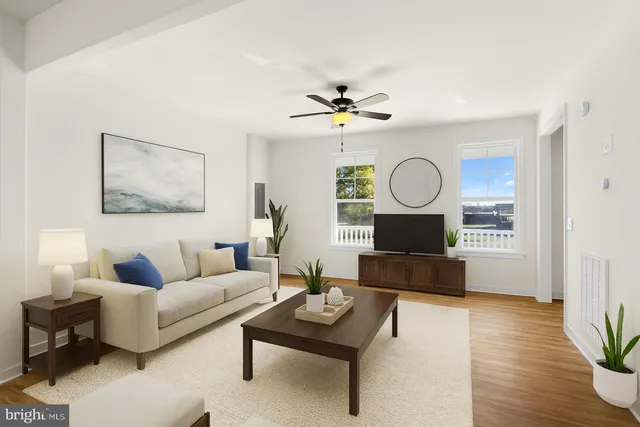 a living room with furniture a wooden floor and a fireplace