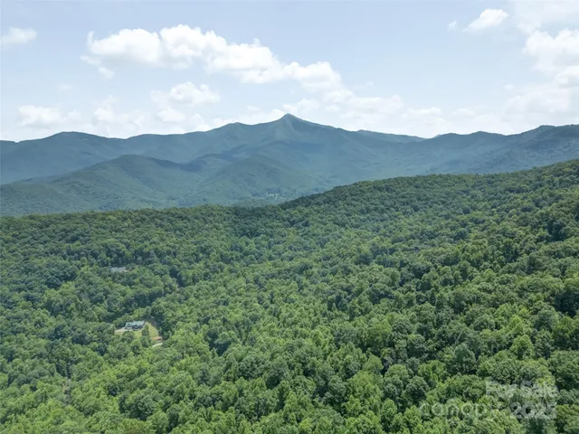a view of a large mountain with mountains in the background