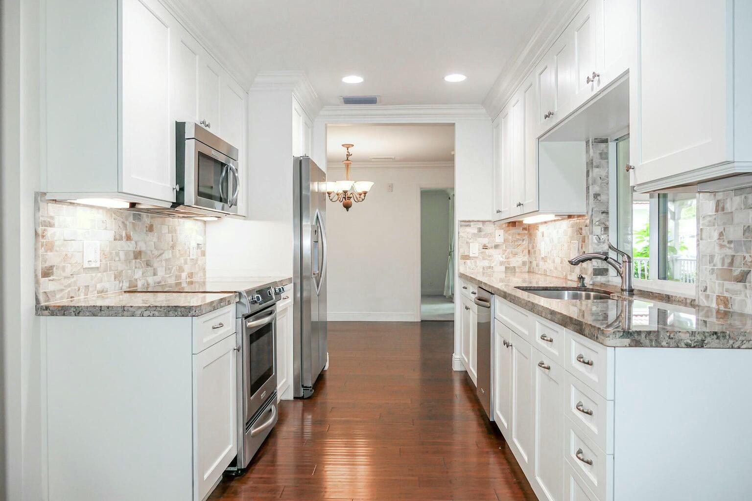 18014 Perigon Way Jupiter, FL 33458 - Photo 10 of 35 a kitchen with stainless steel appliances granite countertop a stove and a sink