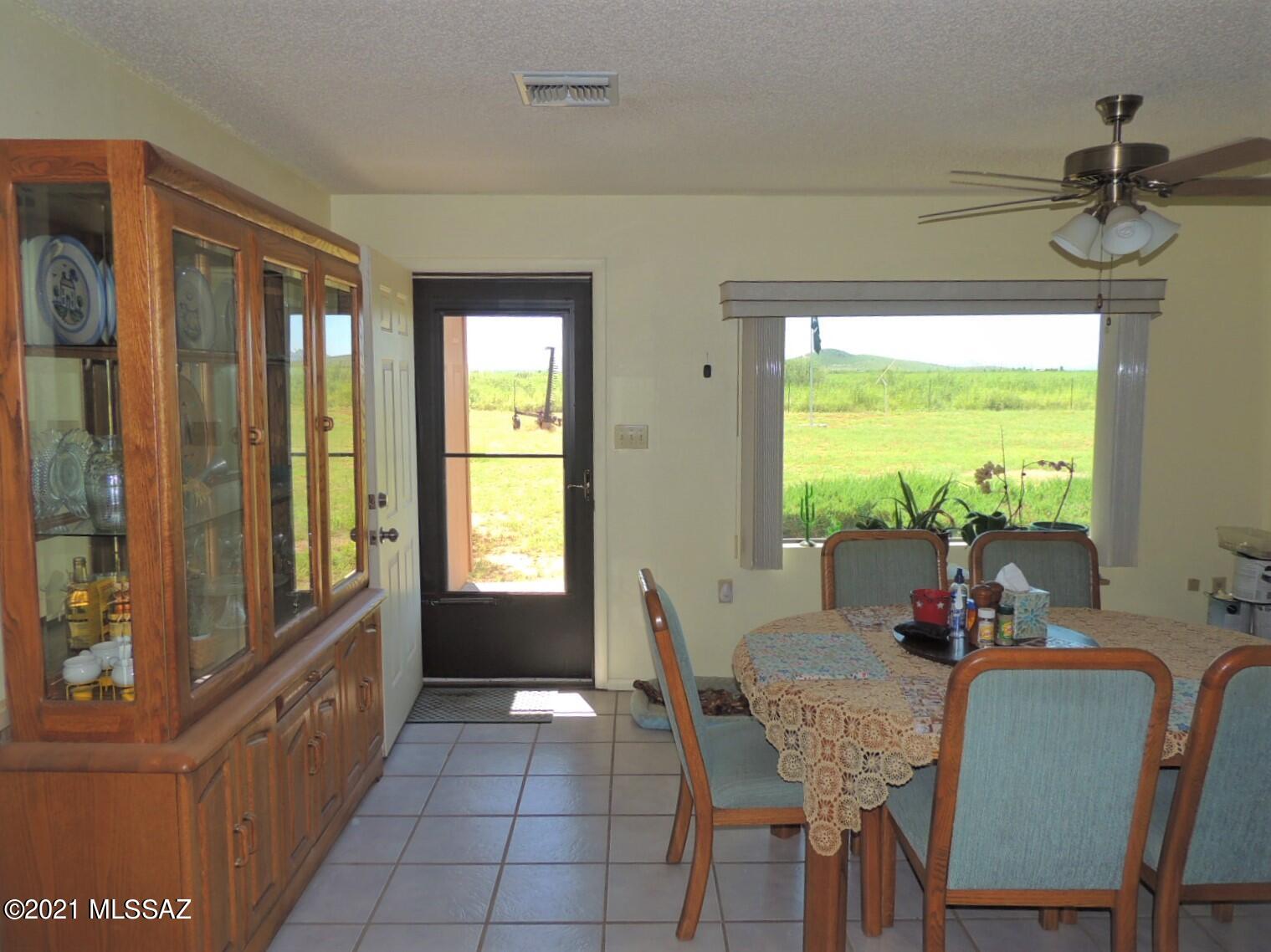 3454 East Fawn Ranch Road Pearce, AZ 85625 - Photo 19 of 49 a dining room with furniture and a window