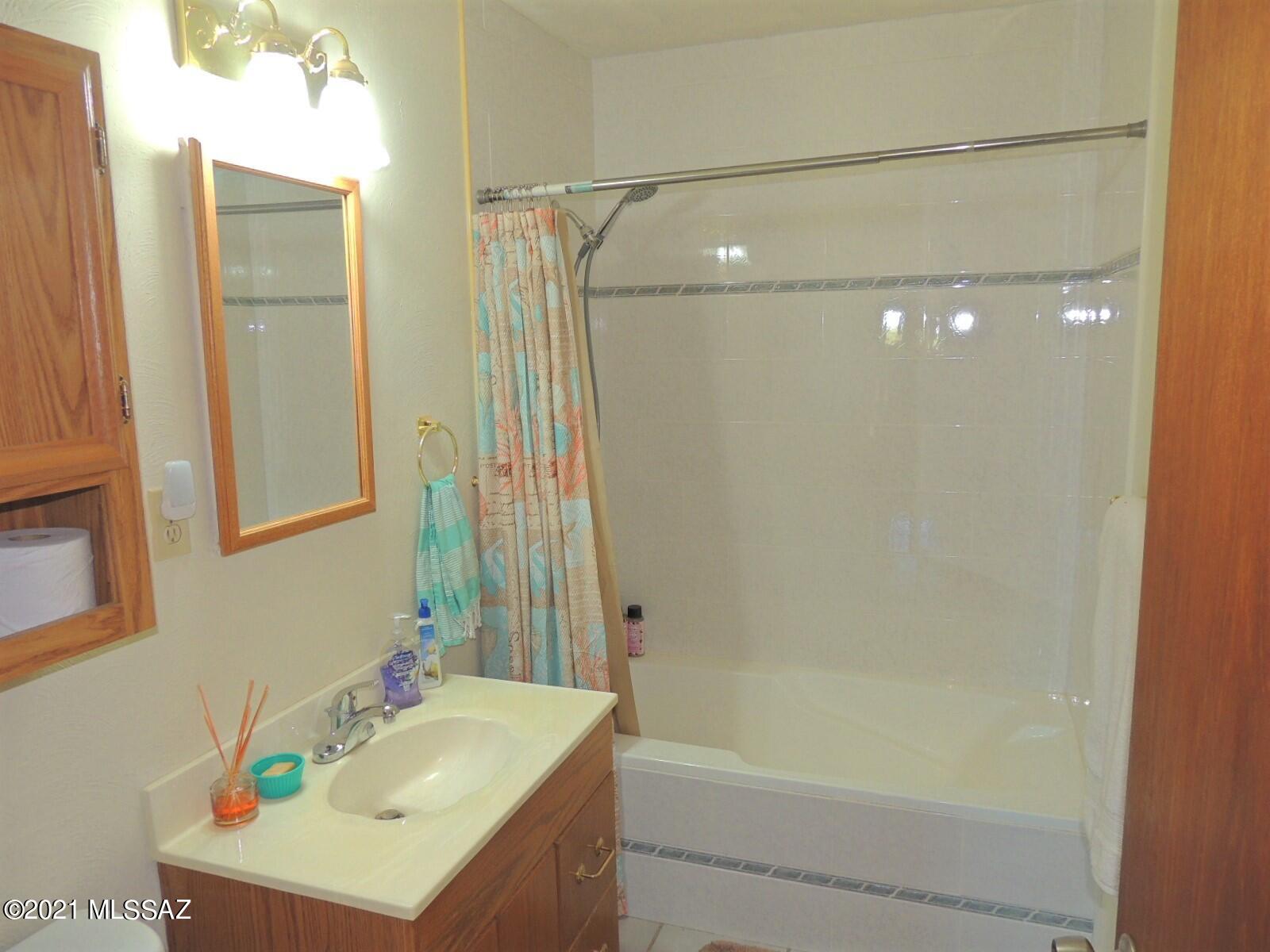 3454 East Fawn Ranch Road Pearce, AZ 85625 - Photo 28 of 49 a bathroom with a sink mirror toilet and bathtub