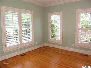 448 South Sharon Amity Road Charlotte, NC 28211 - Photo 3 of 16 a view of an empty room with wooden floor and a window