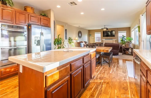 a dining hall with stainless steel appliances granite countertop a stove and a sink
