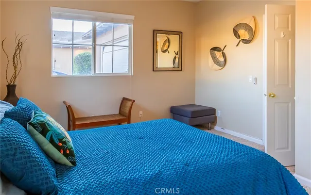 a large bed sitting in a bedroom next to a window