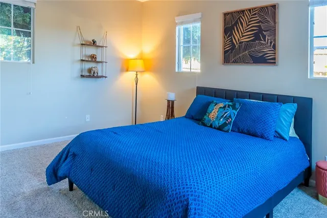 a bed sitting in a bedroom next to a window