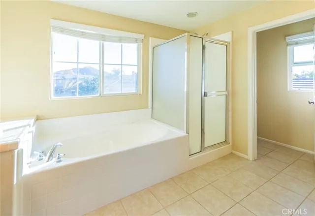 a bedroom with a bed and a lamp on dresser