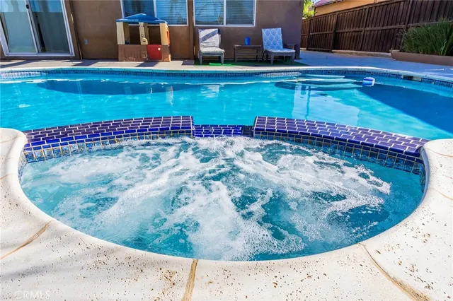 an aerial view of a house with a yard and lake view