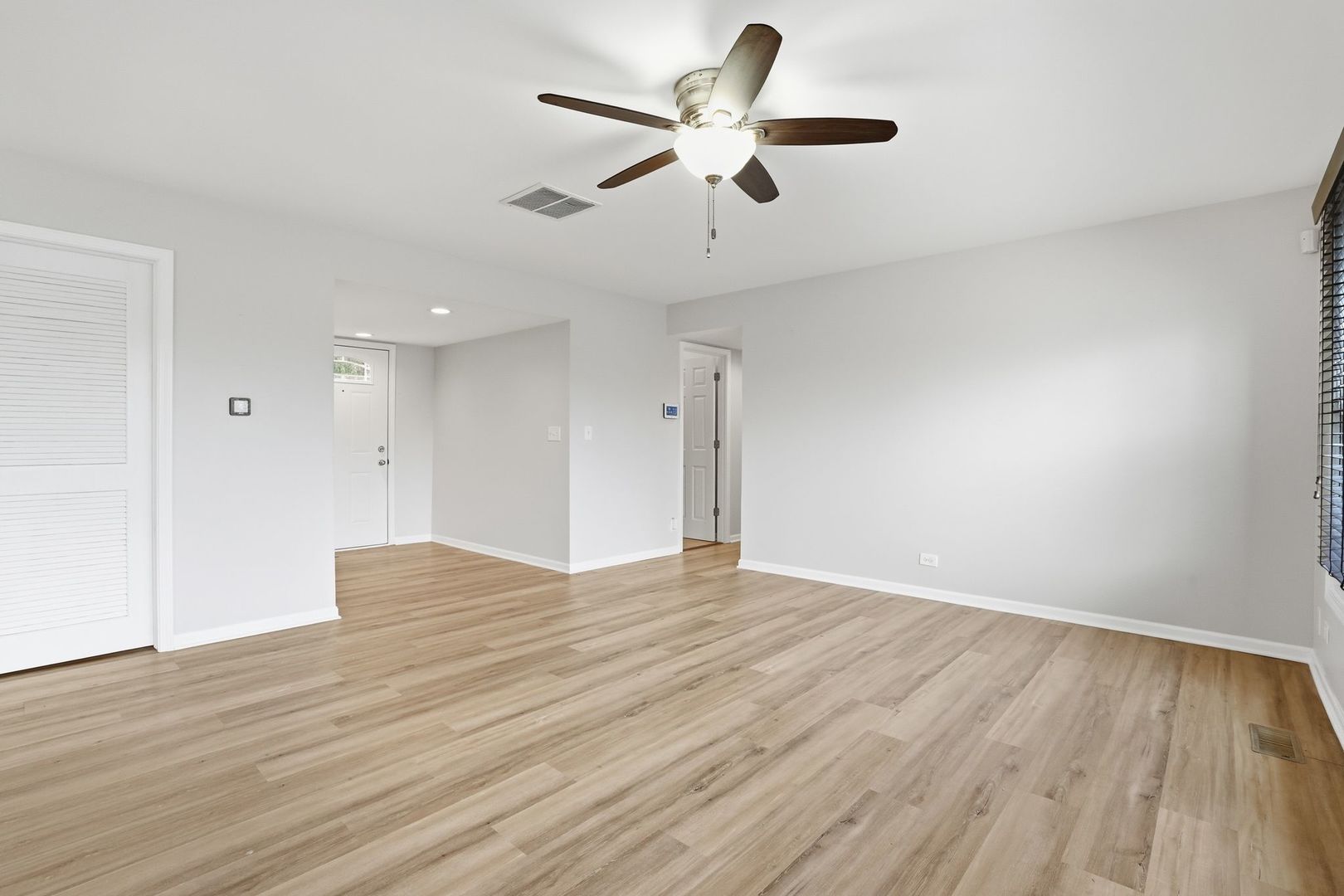 221 Davis Lane Bolingbrook, IL 60440 - Photo 4 of 24 a view of an empty room with wooden floor