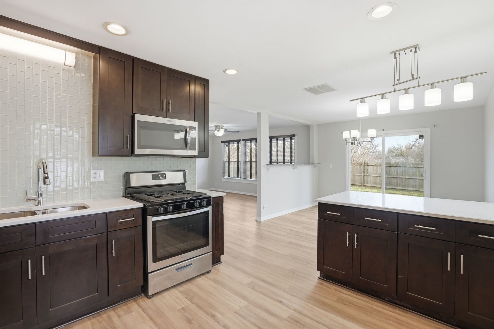 221 Davis Lane Bolingbrook, IL 60440 - Photo 6 of 24 a kitchen with a sink stove and microwave