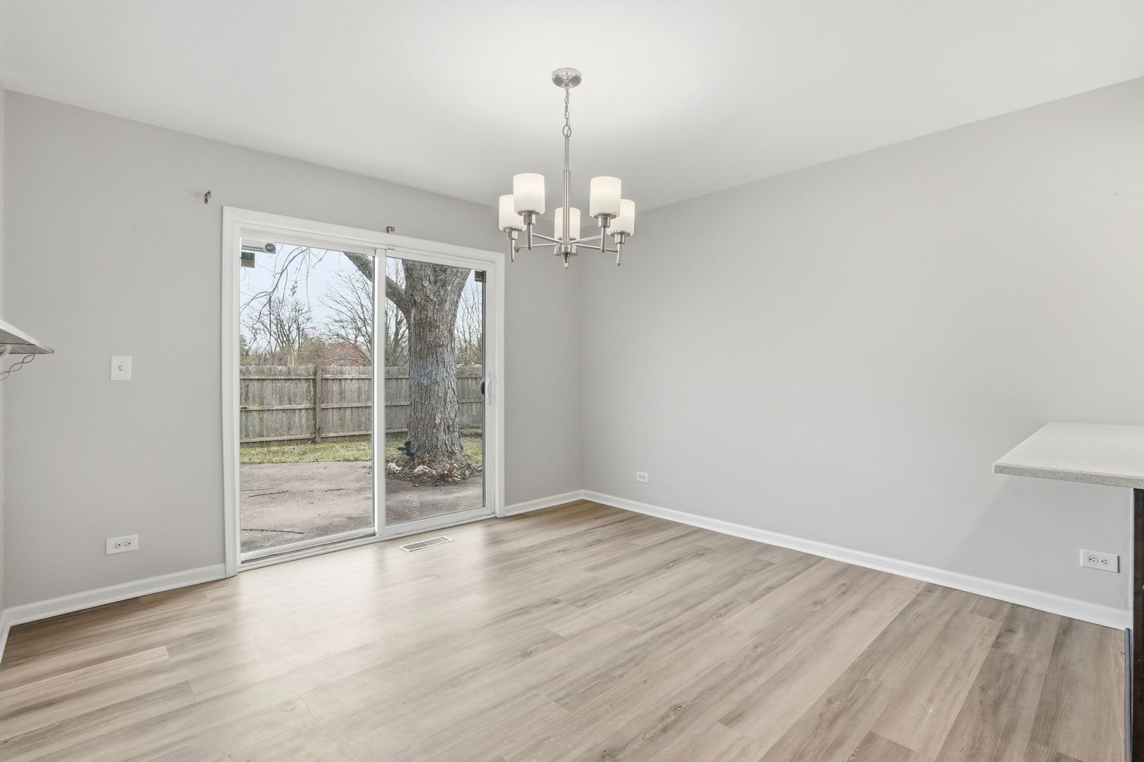 221 Davis Lane Bolingbrook, IL 60440 - Photo 9 of 24 wooden floor in an empty room with a window