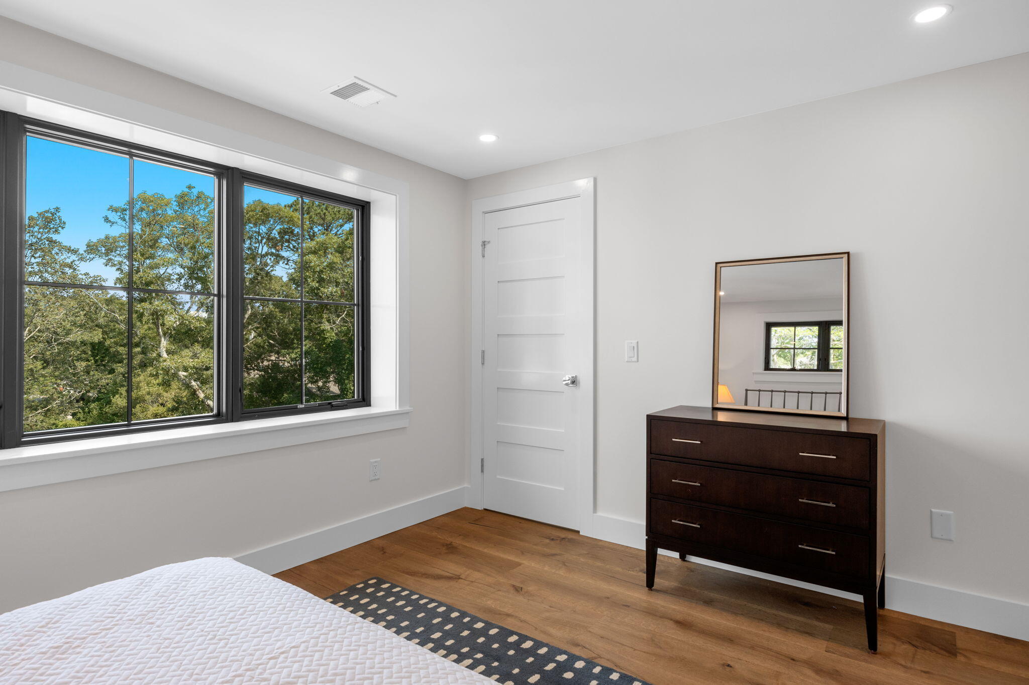 50 Nelson Avenue, Unit 8 Provincetown, MA 02657 - Photo 12 of 21 a bedroom with a bed and a dresser next to a window