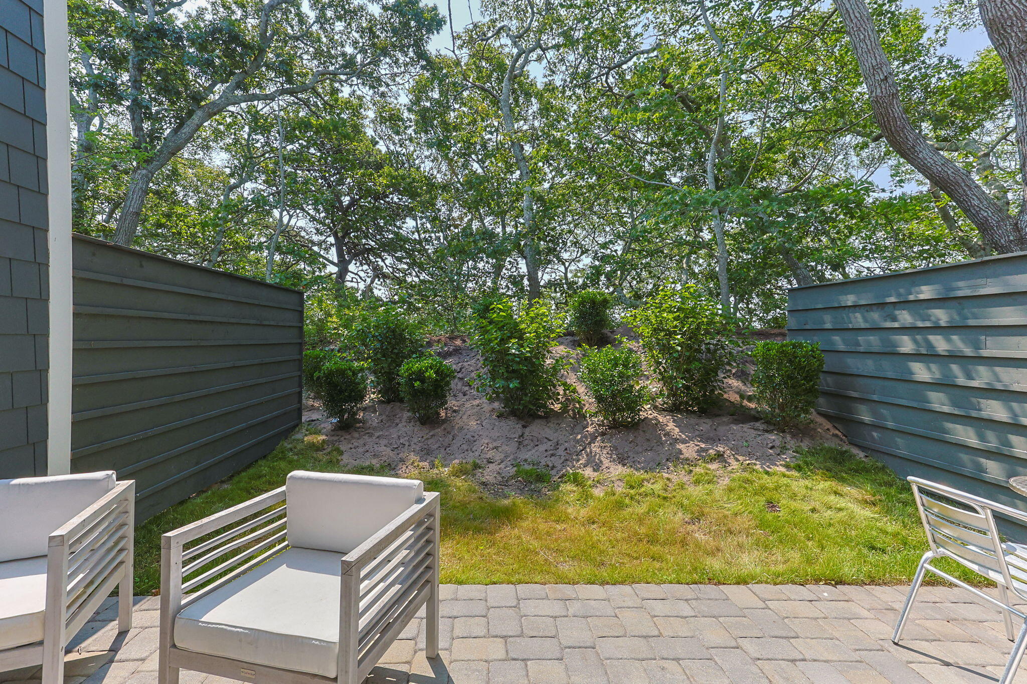 50 Nelson Avenue, Unit 8 Provincetown, MA 02657 - Photo 19 of 21 a backyard of a house with table and chairs