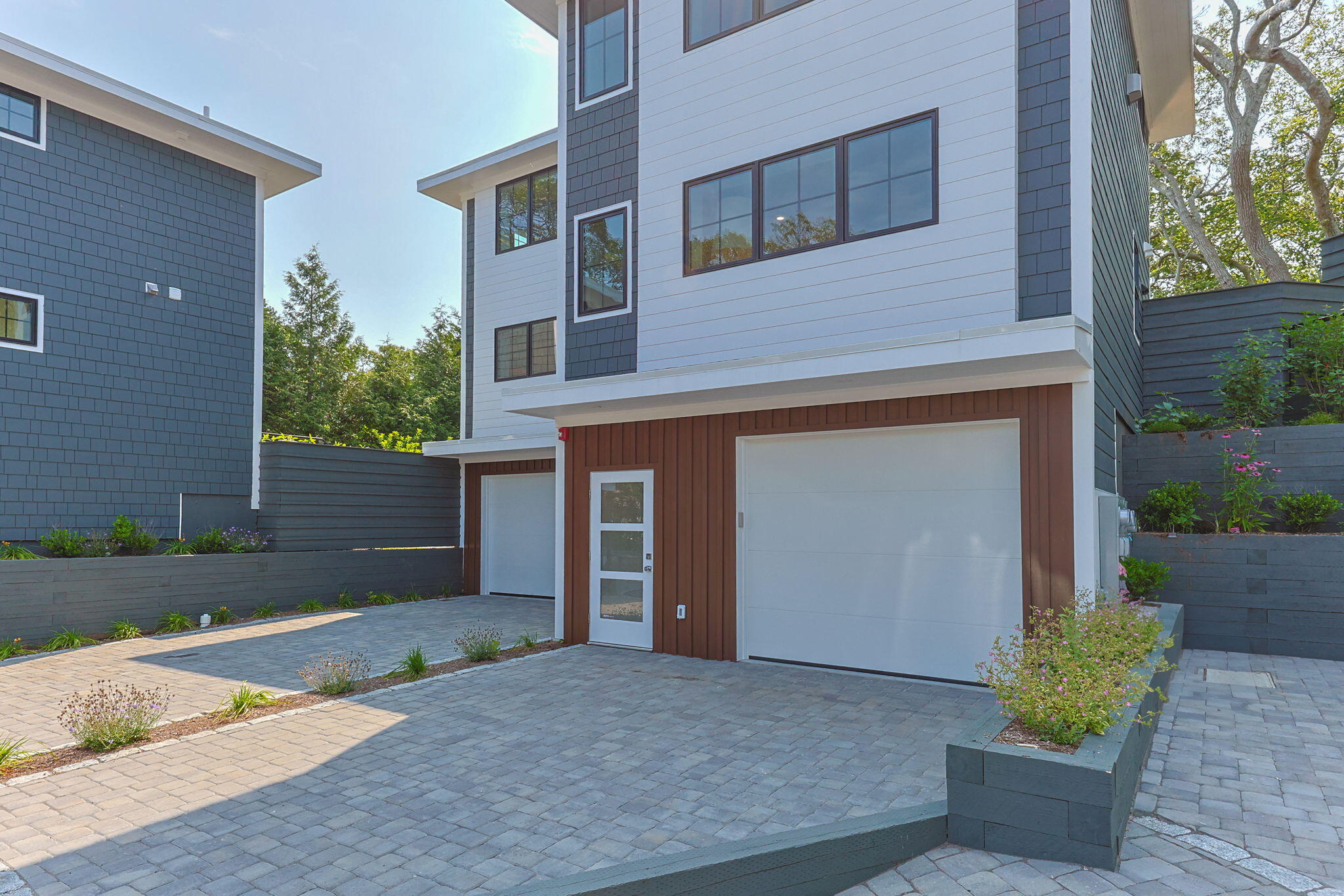 50 Nelson Avenue, Unit 8 Provincetown, MA 02657 - Photo 2 of 21 front view of a house with a yard and a garage