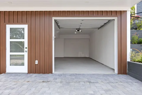 an empty room with closet and windows