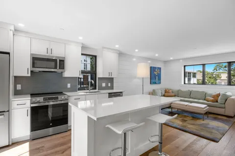 a kitchen with a stove a sink and a refrigerator