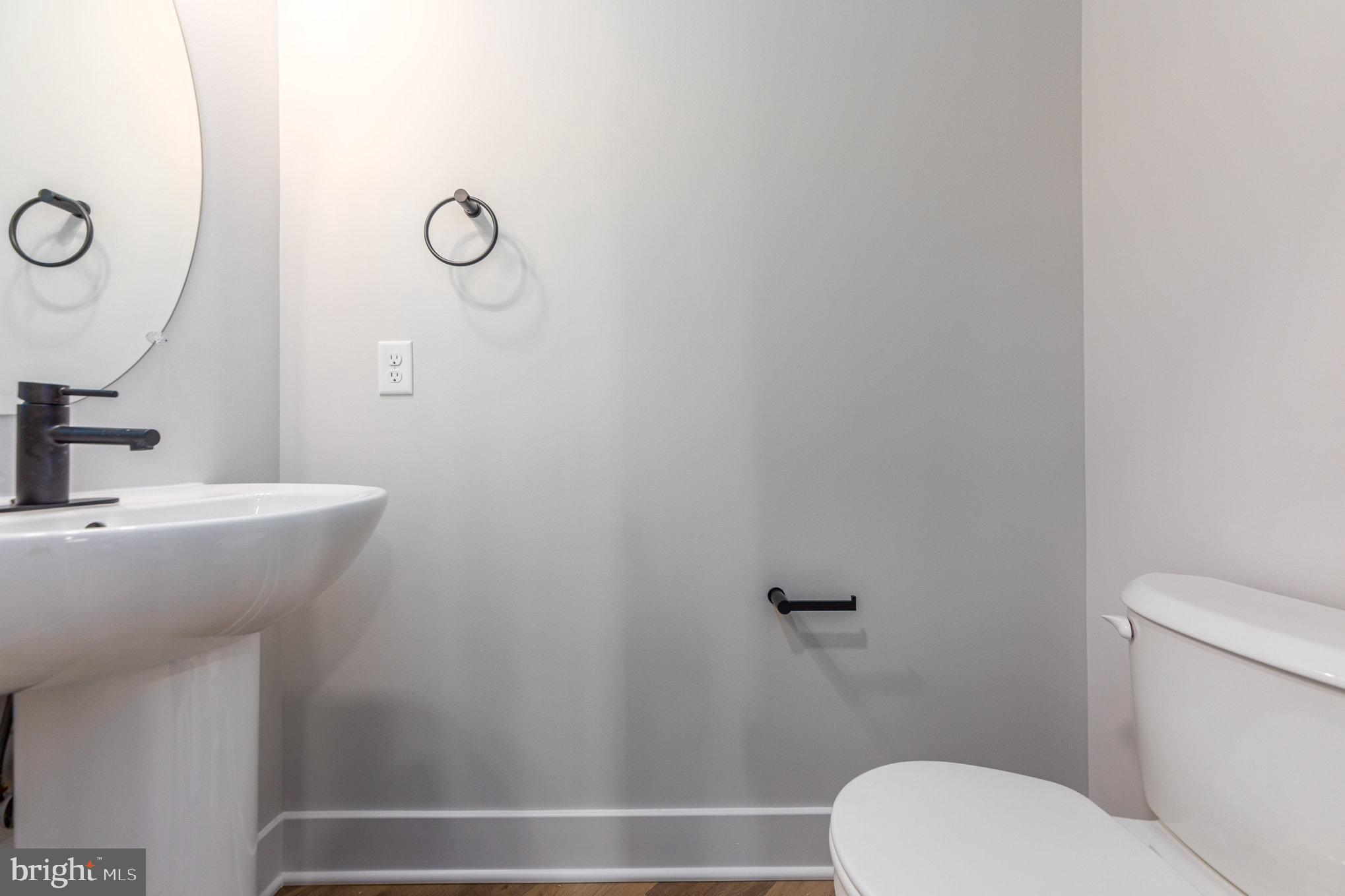 155 Norman Road Stafford, VA 22554 - Photo 24 of 55 a bathroom with a toilet a sink and mirror