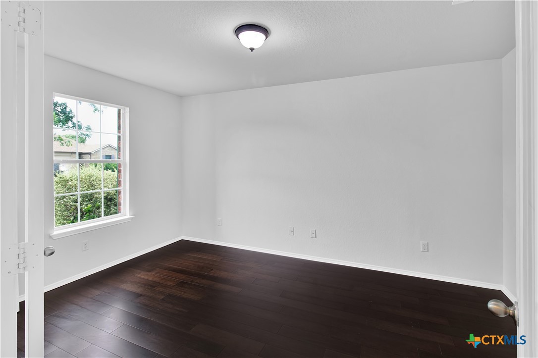 117 Bashaw Loop Temple, TX 76502 - Photo 5 of 20 an empty room with wooden floor and windows