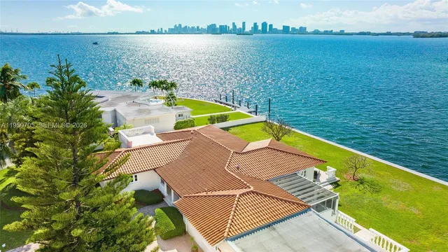 a living room with furniture a clock and a view of kitchen