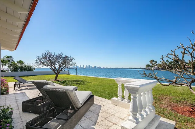 a view of a swimming pool and lounge chairs in the garden