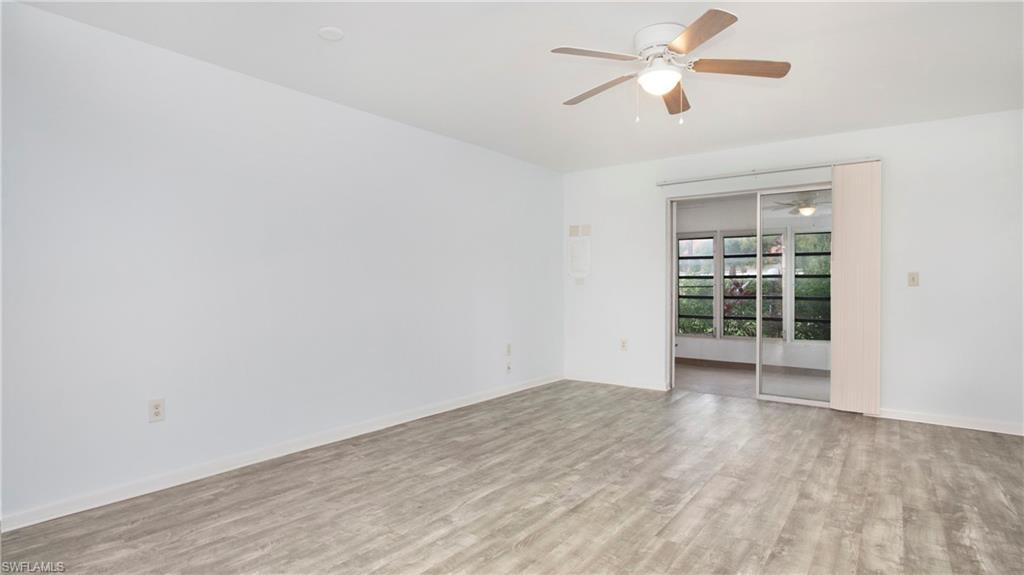 600 Valley Stream Drive, Unit C1 Naples, FL 34113 - Photo 2 of 44 Living area with a ceiling fan and luxury vinyl floors