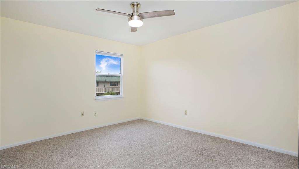 600 Valley Stream Drive, Unit C1 Naples, FL 34113 - Photo 21 of 44 2nd bedroom with light colored carpet and a ceiling fan