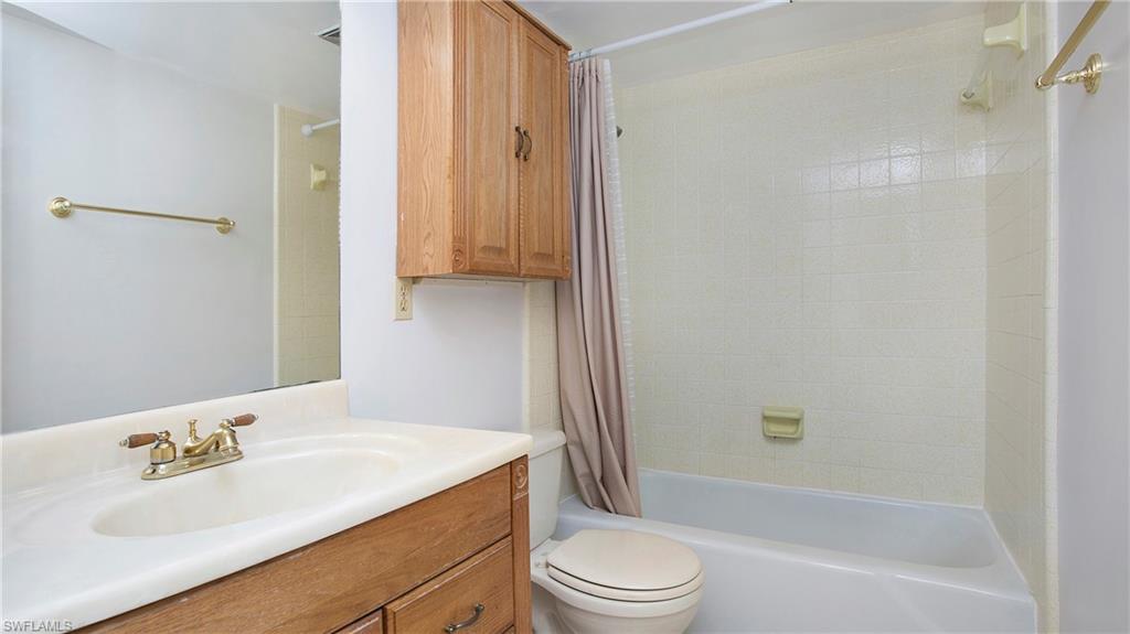 600 Valley Stream Drive, Unit C1 Naples, FL 34113 - Photo 22 of 44 Full bath featuring shower / bath combination with curtain and vanity