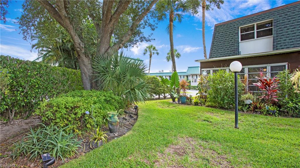 600 Valley Stream Drive, Unit C1 Naples, FL 34113 - Photo 25 of 44 View of grassy yard with mature foliage