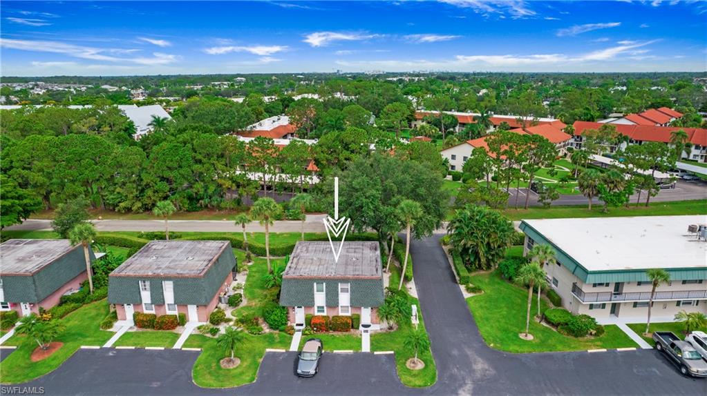 600 Valley Stream Drive, Unit C1 Naples, FL 34113 - Photo 37 of 44 Aerial perspective of suburban area featuring a tree filled landscape