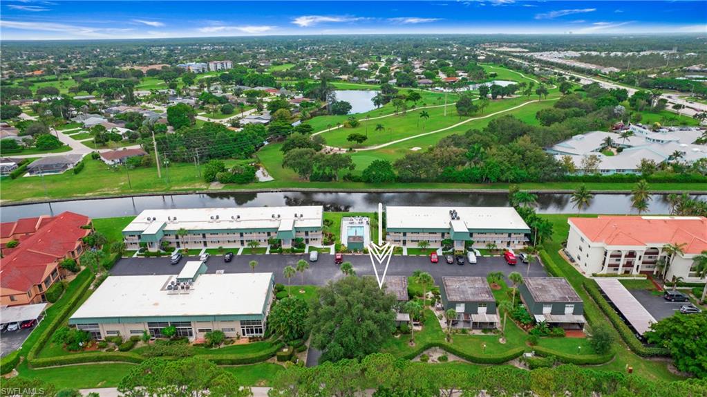 600 Valley Stream Drive, Unit C1 Naples, FL 34113 - Photo 40 of 44 Aerial view of property and surrounding area featuring a large body of water and a local golf course