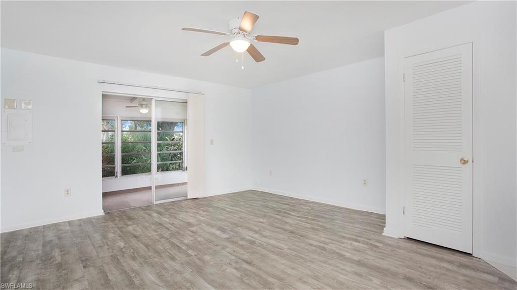 600 Valley Stream Drive, Unit C1 Naples, FL 34113 - Photo 4 of 44 Living area with a ceiling fan and luxury vinyl floors