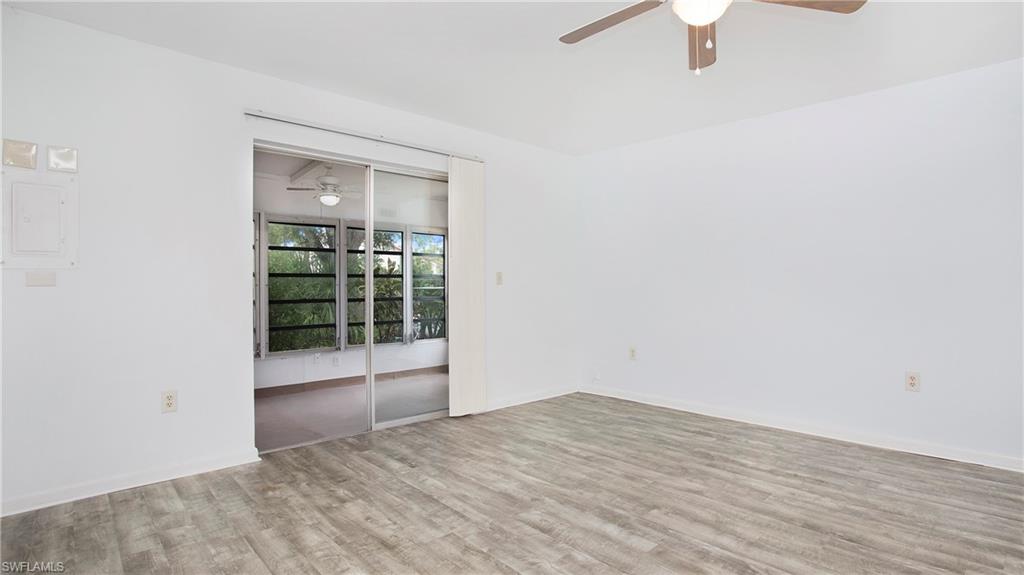 600 Valley Stream Drive, Unit C1 Naples, FL 34113 - Photo 6 of 44 Living area with a ceiling fan and luxury vinyl floors