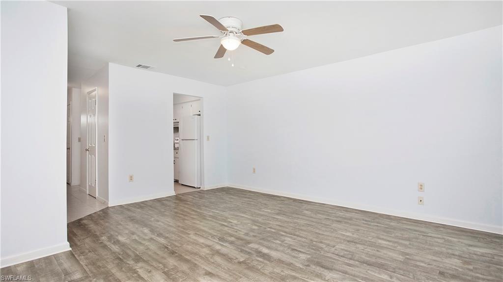 600 Valley Stream Drive, Unit C1 Naples, FL 34113 - Photo 9 of 44 Living area withluxury vinyl floors and ceiling fan