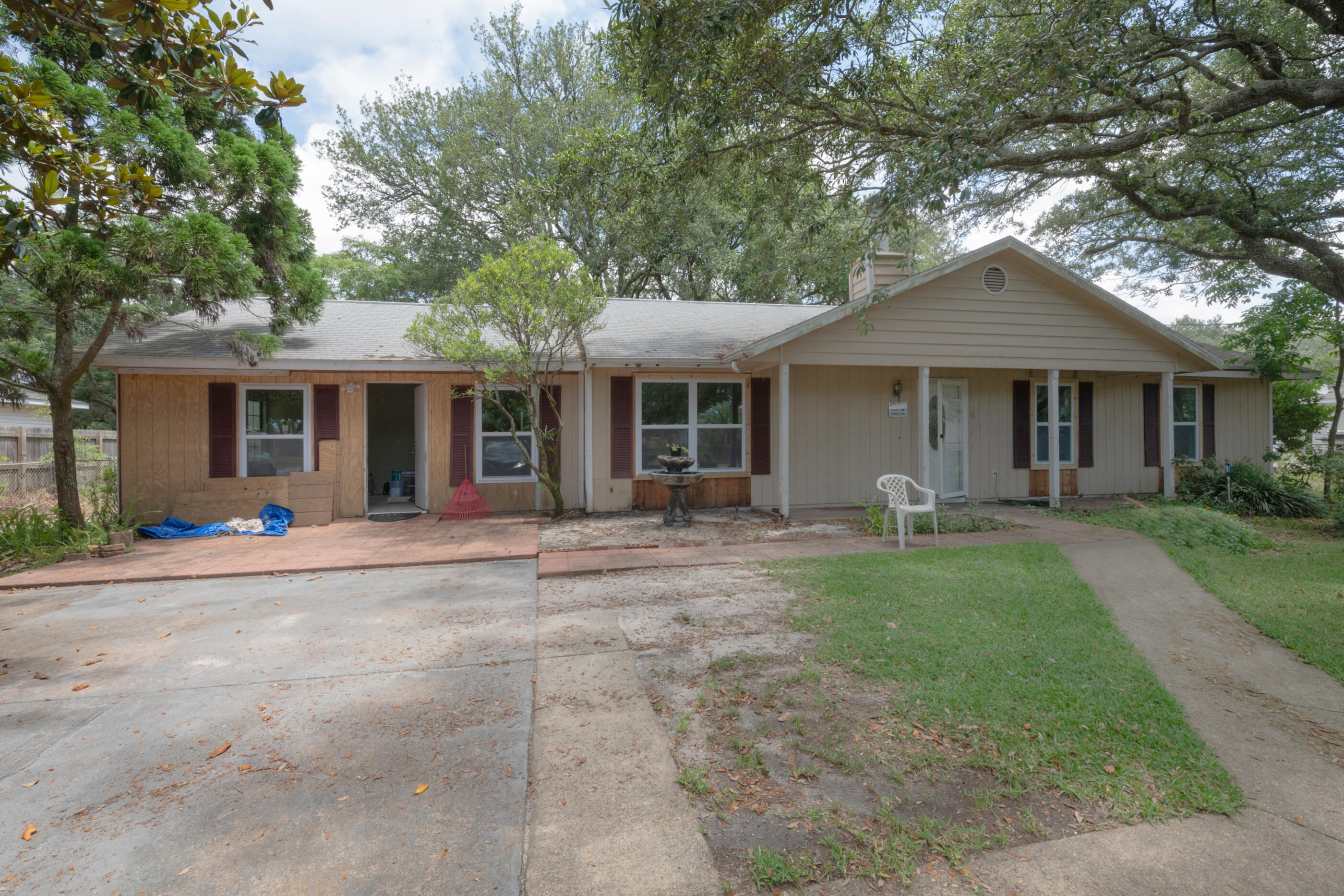 a front view of a house with yard patio and green space