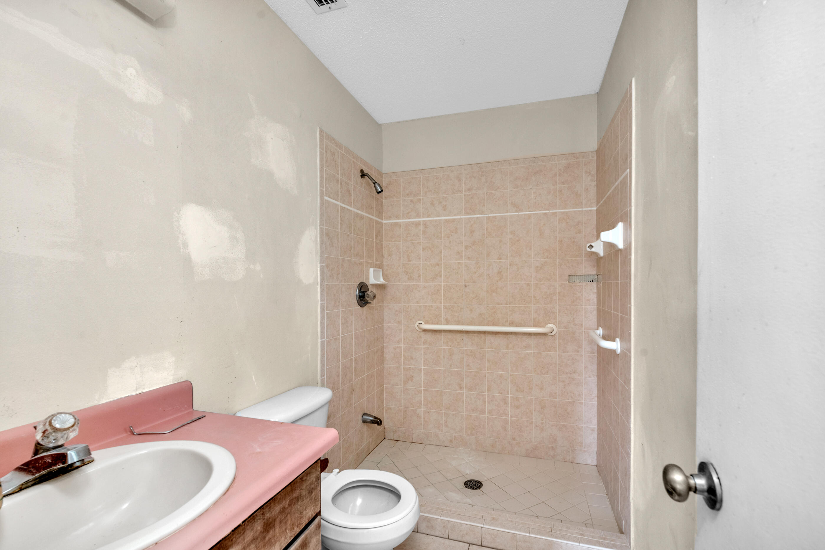 8156 4th Street Navarre, FL 32566 - Photo 15 of 23 a bathroom with a granite countertop sink a toilet and shower