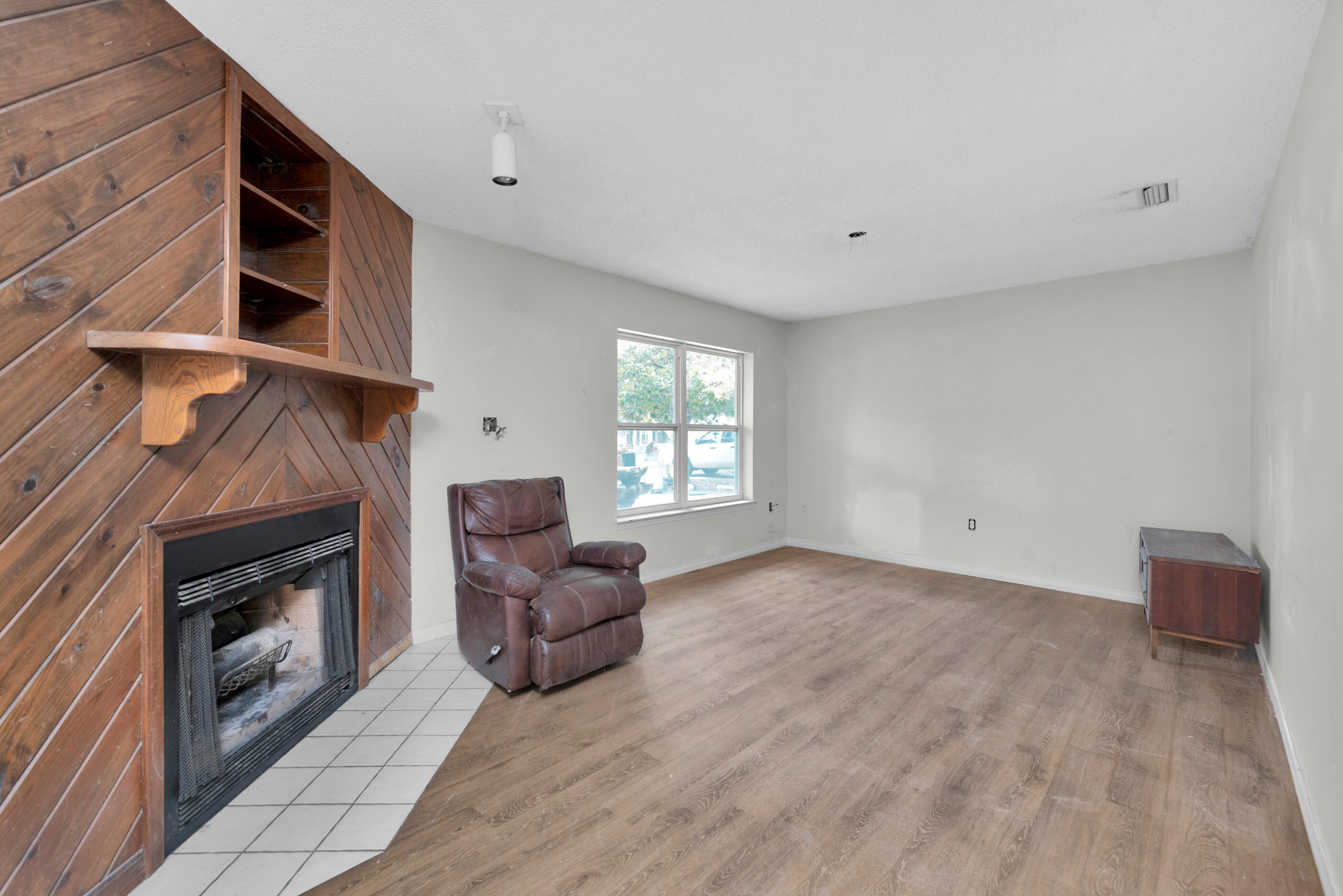 8156 4th Street Navarre, FL 32566 - Photo 4 of 23 a living room with furniture and a fireplace