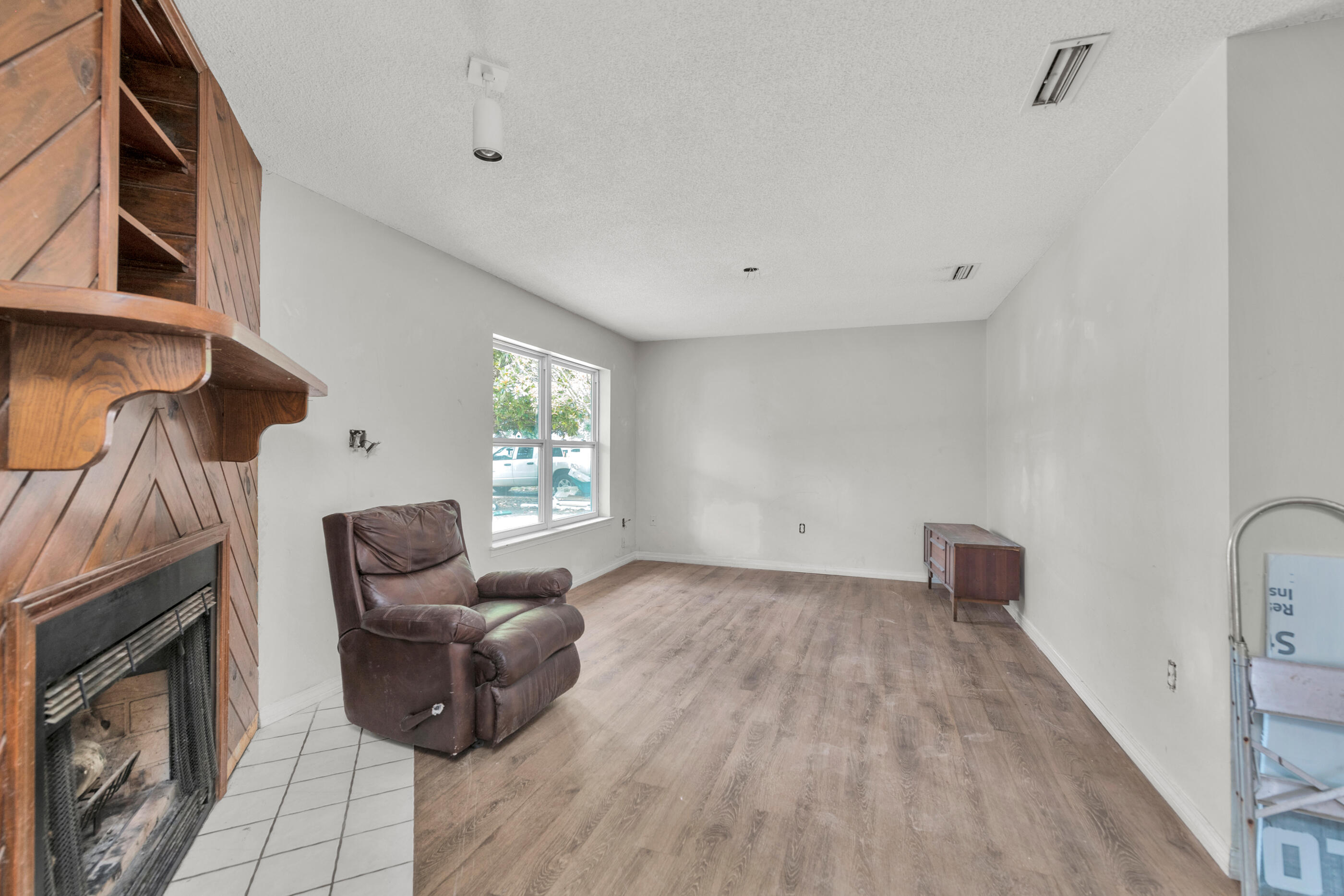 8156 4th Street Navarre, FL 32566 - Photo 5 of 23 a living room with furniture and a fireplace
