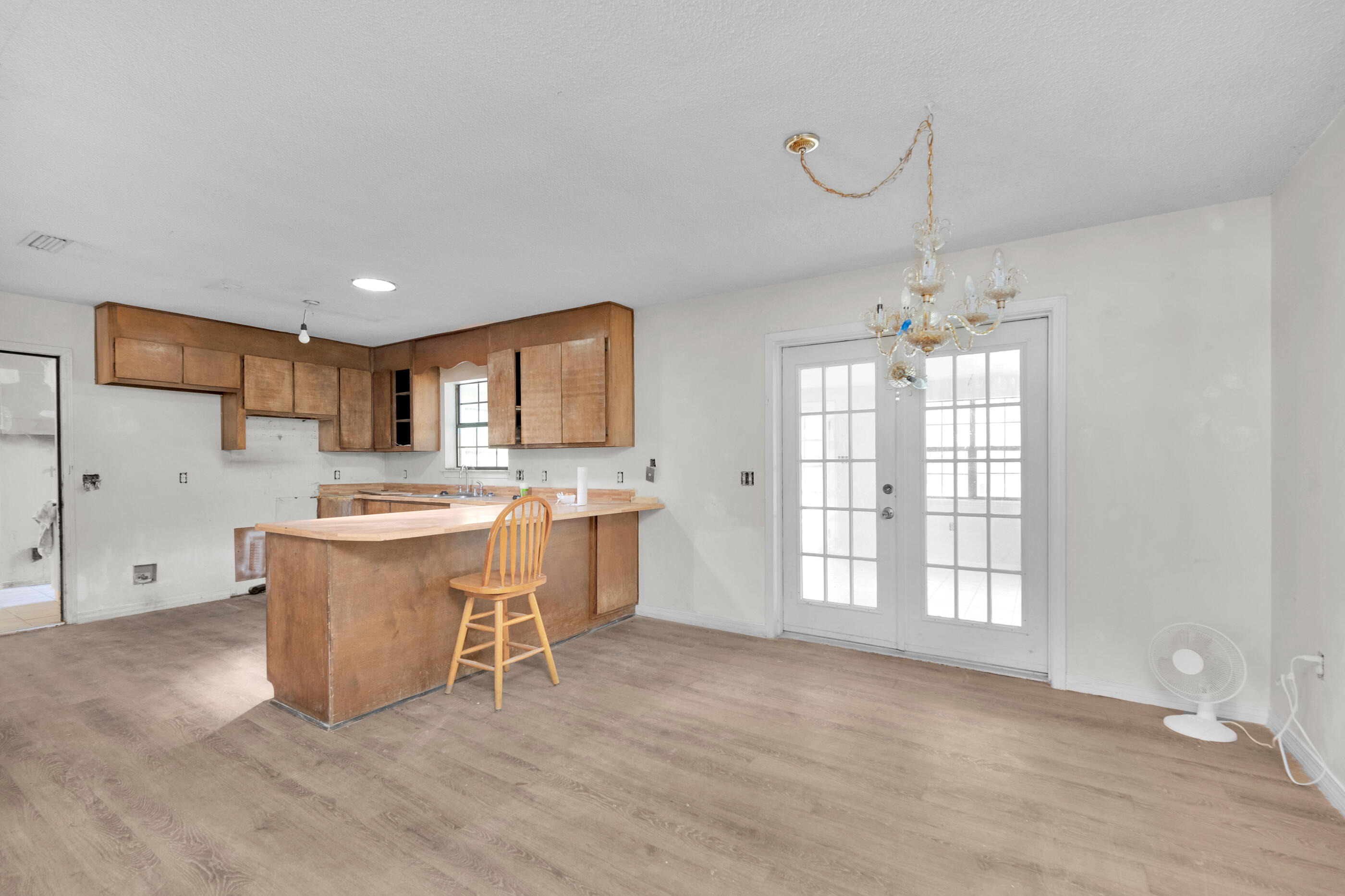 8156 4th Street Navarre, FL 32566 - Photo 6 of 23 a large kitchen with a window and stainless steel appliances