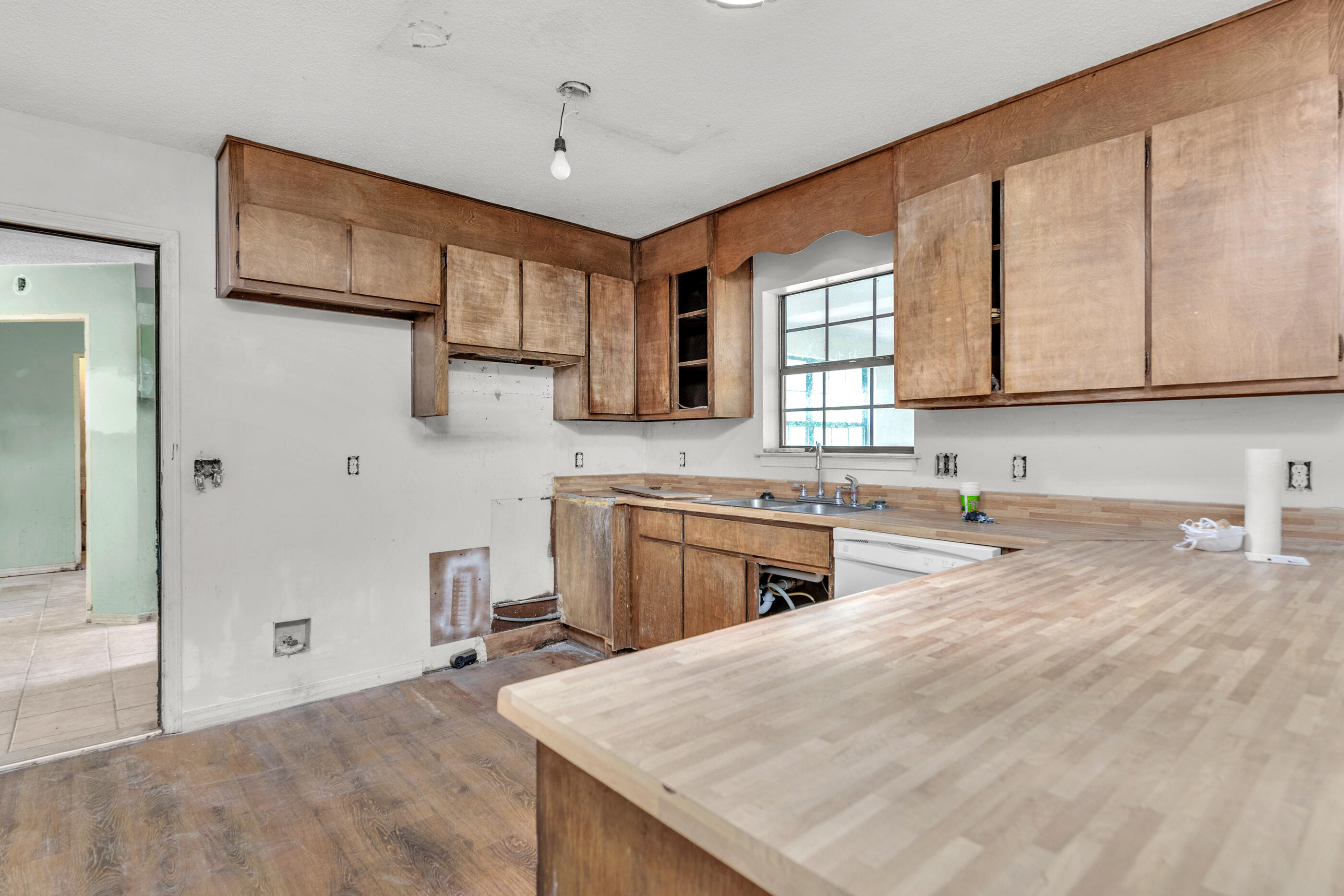 8156 4th Street Navarre, FL 32566 - Photo 9 of 23 a kitchen with stainless steel appliances granite countertop a stove a sink and a refrigerator