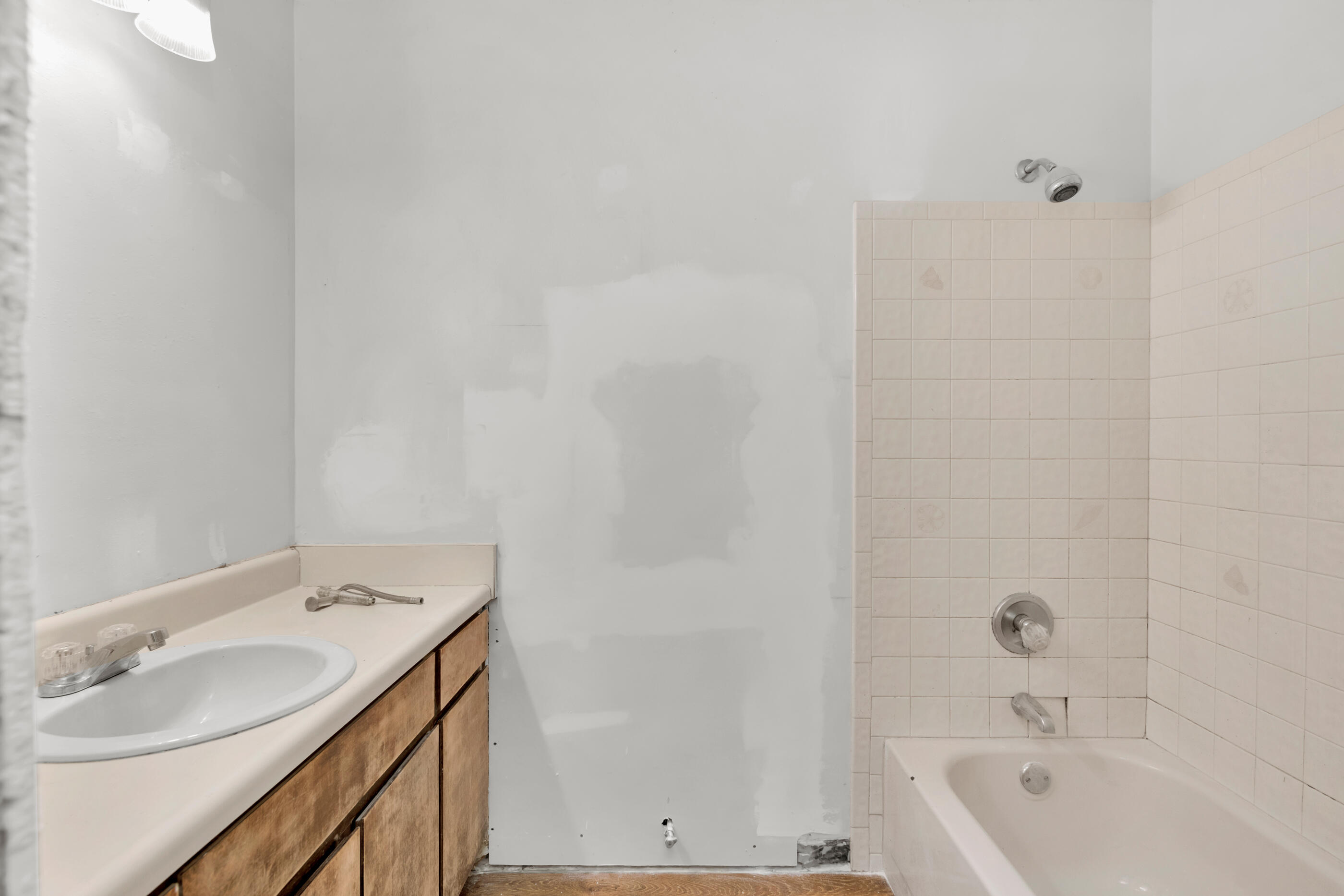 8156 4th Street Navarre, FL 32566 - Photo 10 of 23 a bathroom with a tub sink vanity and mirror