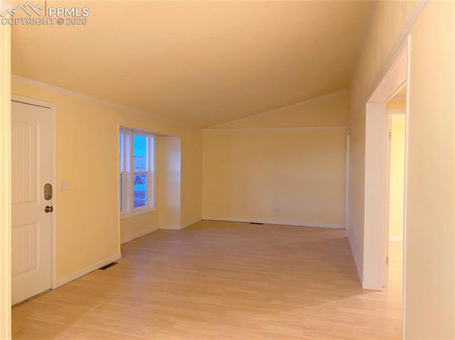 3255 Wiesner Road Calhan, CO 80808 - Photo 2 of 25 Family Room (part of Great Room-Family Room/Kitchen/Dining) w/ New Interior Paint, New Vinyl Windows, Vaulted Ceiling & newer laminate wood flooring....