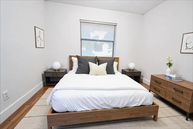 a bedroom with a bed and window