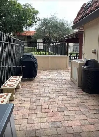 a view of a terrace with chairs and iron fence
