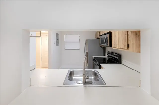 a kitchen that has a sink and a stove