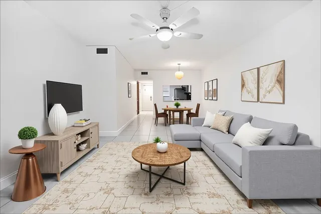 a living room with furniture a dining table and a fireplace