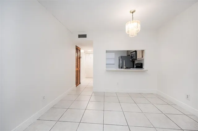 a view of a kitchen with microwave and cabinets