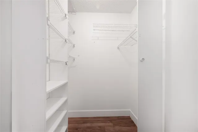 a view of walk in closet with empty racks