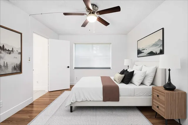 a bedroom with a large bed and a chandelier