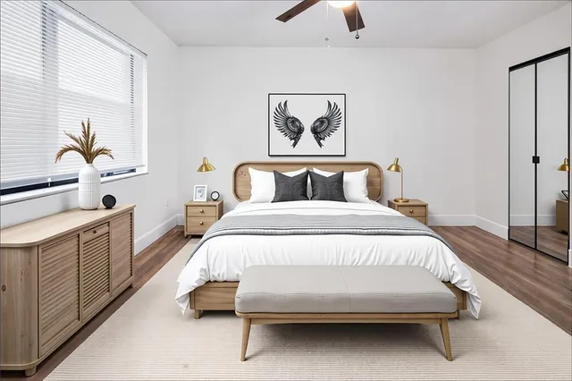 a spacious bedroom with a bed and a cabinets